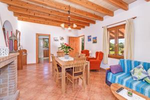 a living room with a table and a couch at Camí d'es Torres in Portopetro