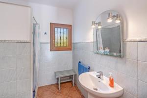 a bathroom with a sink and a mirror and a shower at Camí d'es Torres in Portopetro +17 photos