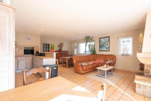 a living room with a couch and a table at Gite du Pibeste - 8 pers in Ouzous