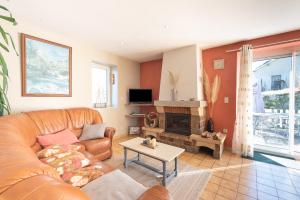 a living room with a couch and a fireplace at Gite du Pibeste - 8 pers in Ouzous