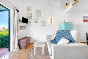 a living room with a couch and a table at Sa Calma House in Cala en Bosc