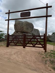 a gate with two large rocks on top of it at Chale Gameleiras in Monte das Gameleiras