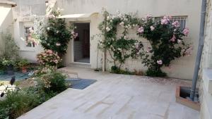 a building with flowers on the side of it at Chambre Hirondelle in L'Ile-Bouchard