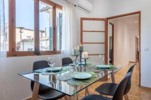 a dining room with a glass table and chairs at Es Llimoner in Sóller +14 photos