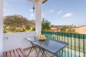 a bowl of fruit on a table on a balcony at Es Llimoner in Sóller