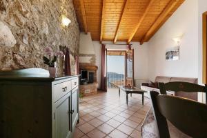 a kitchen and living room with a couch and a table at Rustico Spagnol 4 in Tignale