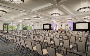 a large room with rows of chairs and a screen at The Scott Resort & Spa in Scottsdale +36 photos