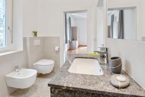 a bathroom with a sink and a toilet at Ferienwohnung Daniela in Merano