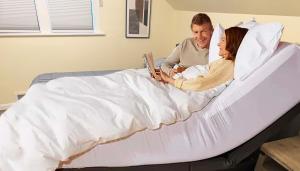 a man and a woman laying in bed with a book at Northend Tacoma Charmer in Tacoma +29 photos