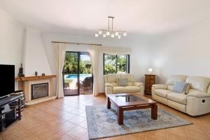 a living room with two couches and a coffee table at Villa Formosa in Almancil