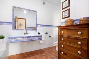 a bathroom with a sink and a toilet and a mirror at Las Raíces in Pájara +24 photos