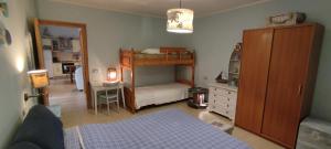 a bedroom with a bed and a bunk bed at Podere Le Palme in Castiadas