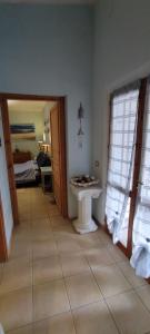 a bathroom with a white sink in a room at Podere Le Palme in Castiadas +27 photos