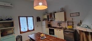 a kitchen with a table and a counter top at Podere Le Palme in Castiadas