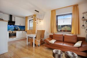 a living room with a couch and a table at Ferienwohnung Marinas Alpenblick in Inzell
