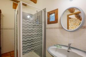 a bathroom with a shower and a sink and a mirror at Chambre La Louve in Banne