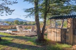 a backyard with a table and chairs and a gazebo at Chambre La Louve in Banne