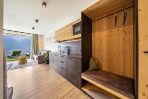a kitchen with a large wooden door in a room at Paflur Lodges Lärchenduft in Lasa +9 photos
