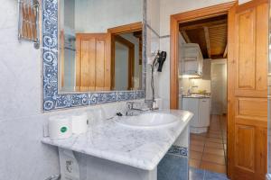 a bathroom with a sink and a mirror at Apartamentos El Rincón de Bustio in Bustio +70 photos