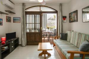 a living room with a couch and a table at Villa Amanda in Playa del Cura