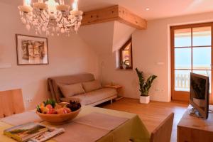 a living room with a table with a bowl of fruit on it at Rosengartnerhof Apt Gantkofel in Terlano