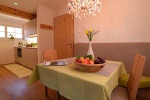a dining room table with a bowl of fruit on it at Rosengartnerhof Apt Gantkofel in Terlano