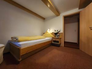 a bedroom with a bed and a table with a lamp at Alte Schmiede 2 Fewos in Feldberg