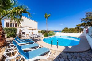 a group of blue lounge chairs next to a swimming pool at Trevol Suits in Cielo de Bonaire 