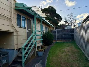 a house with a green railing on the side of it at Eunoia at Smiths in Smiths Beach +4 photos
