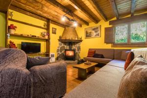 a living room with a couch and a fireplace at La Hirriria in San Roque de Ríomiera