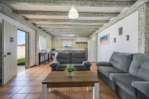 a living room with a couch and a table at Villa Ibicenca in Vejer de la Frontera