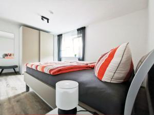 a bedroom with a bed with a black leather headboard at Fuchsbau in Baiersbronn