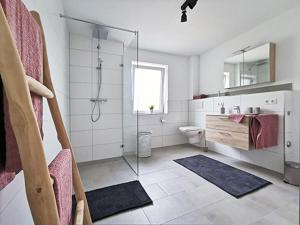 a bathroom with a shower and a toilet and a sink at Fuchsbau in Baiersbronn +22 photos