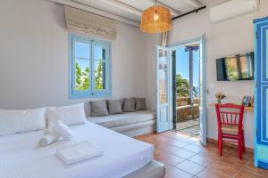 a living room with a white couch and a table at La Casa Tinos 22 in Tinos