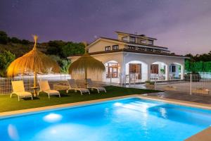 a house with a swimming pool in front of a house at Fidalsa Imperial Malibu in Elche