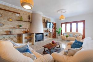 a living room with two couches and a fireplace at Fidalsa Imperial Malibu in Elche