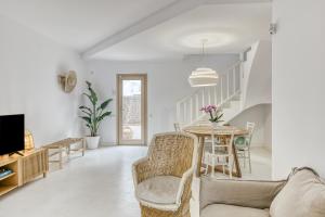 a living room with a table and chairs at Villa la Barrufa in S'agaro