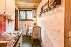 a kitchen with a counter and a table in it at Am Wehrastrand App 4 in Todtmoos