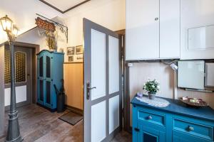 a kitchen with blue cabinets and a blue door at Studio zur »Alten Schmiede« in Laage