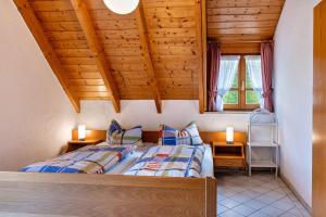 two beds in a room with wooden ceilings at Gasthaus Zur Linde- Napf in Oberried