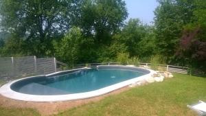 a swimming pool in a yard with a fence at Colleincanto Appartamento Torretta in Gavardo