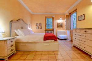 a bedroom with a large bed and a dresser at Colleincanto Appartamento Torretta in Gavardo +22 photos