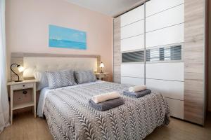 a bedroom with a bed with two pillows on it at Apartamento Rocas Negras in Puerto del Carmen +14 photos