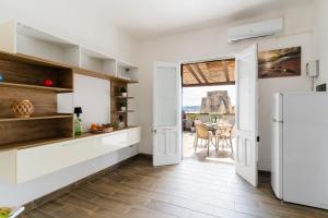 a kitchen with a refrigerator and a table at Casa Azzurra a Torre dell'Orso in Torre dell'Orso