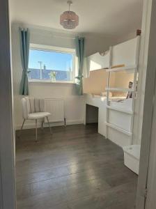 a small room with a bed and a chair and a window at Central Highland Escape in Caol +11 photos
