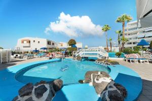 a large swimming pool with rocks in a resort at Club Atlantis with views in Adeje
