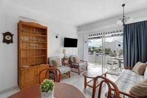a living room with a couch and a table at Club Atlantis with views in Adeje