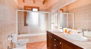 a bathroom with a toilet and a sink and a shower at Can Mates Nou in Campos +28 photos