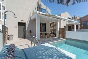 a villa with a swimming pool and a house at Mella Roa - Villa Onyx in Nydri