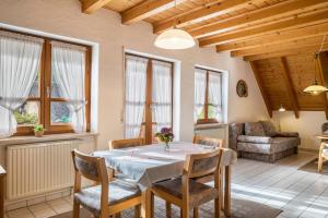 a living room with a table and chairs and a couch at Gasthaus Zur Linde- Napf in Oberried